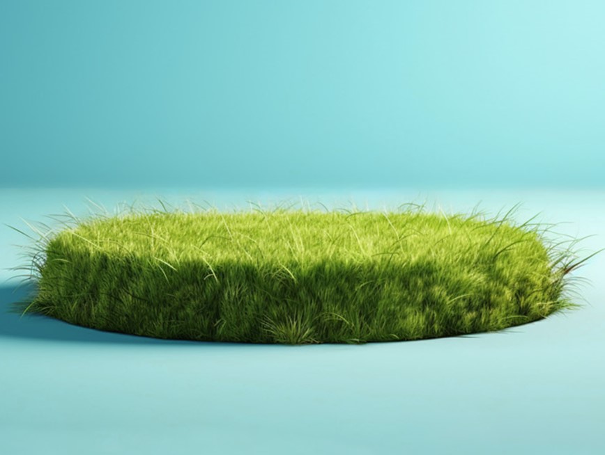 A circular pile of green grass in the center of a light blue room