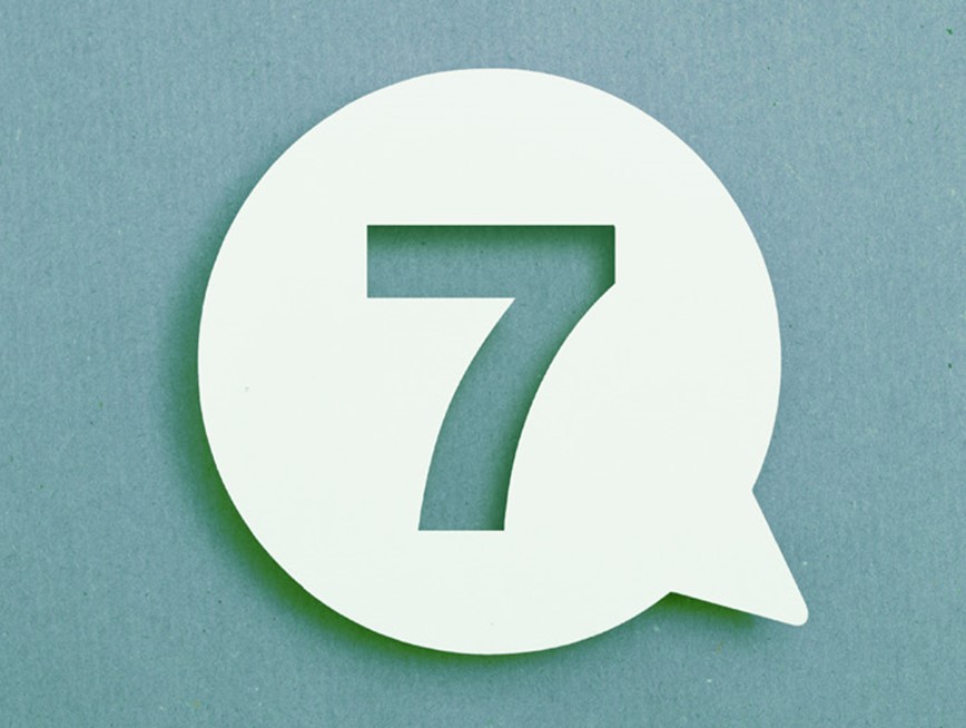 The number seven in a speech bubble against a teal background