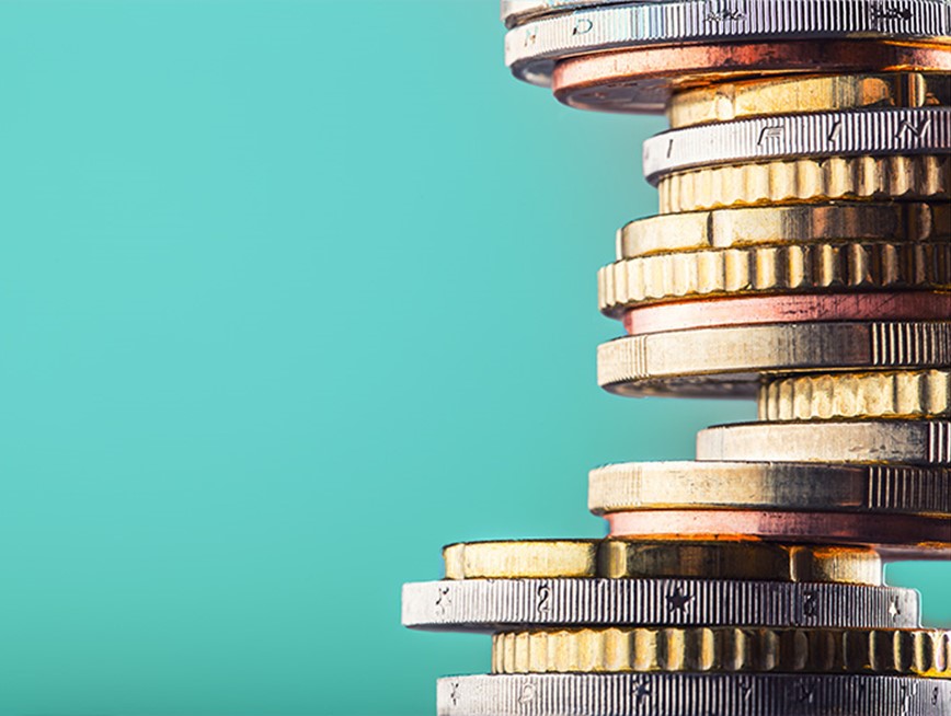 A stack of coins against a teal background